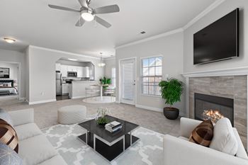 a living room with a fireplace and a flat screen tv